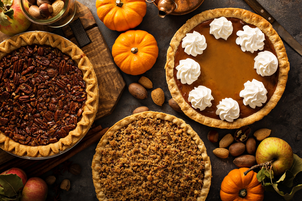 Fall traditional pies pumpkin, pecan and apple crumble pie overhead shot