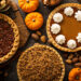 Fall traditional pies pumpkin, pecan and apple crumble pie overhead shot